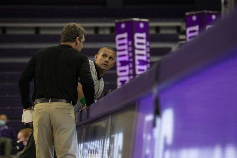 Iowa Head Coach Tom Brands speaks to officials during a dual at Welsh-Ryan Arena in Evanston, IL. Moments later, officials corrected the team score. The Hawkeyes defeated the Wildcats 33-6.