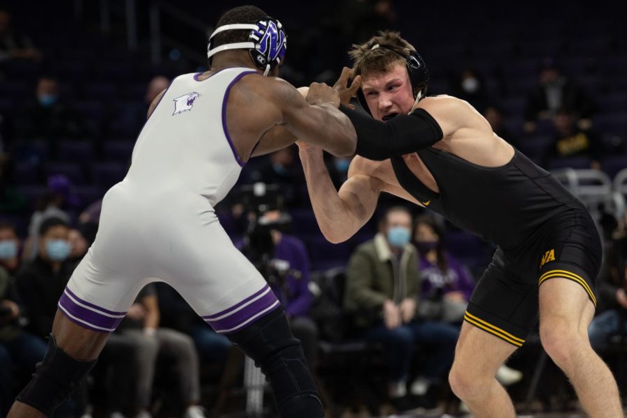 Iowa’s 149-pound No. 12 Max Murin wrestles Northwestern’s No. 5 Yahya Thomas during a dual at Welsh-Ryan Arena in Evanston, IL. Murin defeated Thomas 4-3.