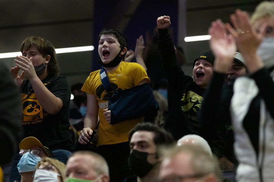 Iowa fans cheer during a wrestling dual between No. 2 Iowa and No. 23 Northwestern at Welsh-Ryan Arena in Evanston, Illinois on Friday, Jan. 14, 2022. The Hawkeyes defeated the Wildcats (Jenna Galligan/The Daily Iowan)