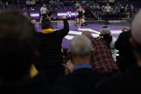 Fans cheer for Iowa’s 149-pound No. 12 Max Murin wrestling Northwestern’s No. 5 Yahya Thomas during a dual at Welsh-Ryan Arena in Evanston, IL. Murin defeated Thomas 4-3.
