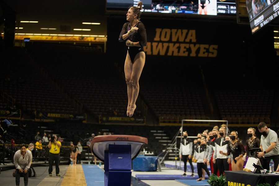 Iowa junior Linda Zivat attempts to complete the vault during a gymnastics meet between Iowa and Texas Women’s University at Carver-Hawkeye Arena on Friday, Jan. 14, 2022. The Hawkeyes defeated the Pioneers, 196.125 - 189.300. Zivat scored 9.825 during her run on the Vault.