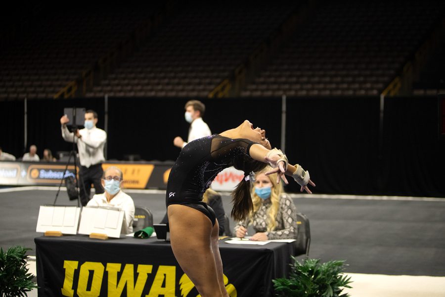 Iowa sophomore Adeline Kenlin celebrates after she finishes the vault during a gymnastics meet between Iowa and Texas Women’s University at Carver-Hawkeye Arena on Friday, Jan. 14, 2022. The Hawkeyes defeated Texas Women’s Pioneers, 196.125-189.300. Kenlin finished the night with 38.800 points in her all-around.