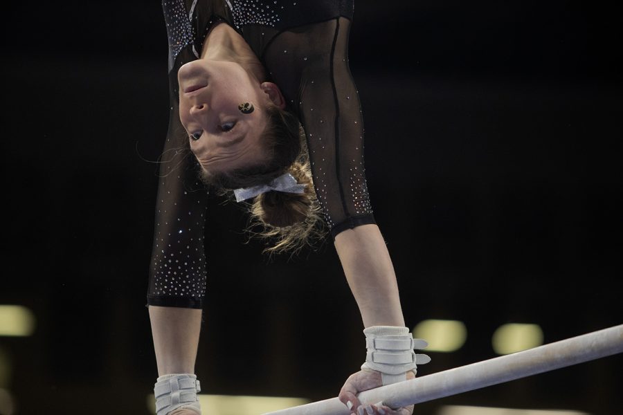 Iowa senior Mackenzie Vance performs on bars during a gymnastics meet between Iowa and Texas Women’s University at Carver-Hawkeye Arena on Friday, Jan. 14, 2022. Vance scored 9.825 points in the bar portion. The Hawkeyes defeated Texas Women’s Pioneers, 196.125-189.300.