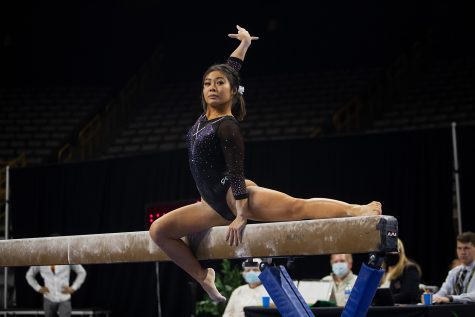 Iowa senior Clair Kaji perform on the beam during a gymnastics meet between Iowa and Texas Women’s University at Carver-Hawkeye Arena on Friday, Jan. 14, 2022. Kaji finished the beam portion with 9.900 points. The Hawkeyes defeated the Pioneers, 196.125-189.300.