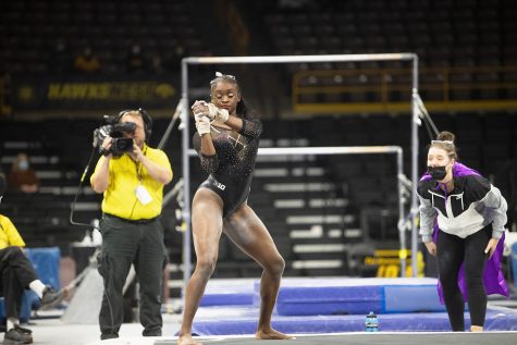 Iowa’s JerQuavia Henderson performs her floor routine during a gymnastics meet between Iowa and Texas Women’s University at Carver-Hawkeye Arena on Friday, Jan. 14, 2022. Henderson took first place for her floor routine with 9.900 points. The Hawkeyes defeated the Pioneers, 196.125-189.300.