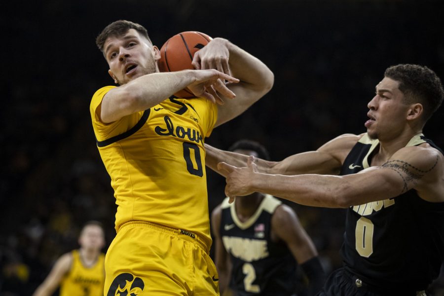 Iowa forward Filip Rebraca attempts to rebound the ball during a basketball game between Iowa and No. 6 Purdue at Carver-Hawkeye Arena in Iowa City on Thursday, Jan. 27, 2022. The Boilermakers defeated the Hawkeyes, 83-73. Iowa had 17 defensive rebounds.