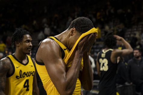 Iowa forward Kris Murray wipes his face after a basketball game between Iowa and No. 6 Purdue at Carver-Hawkeye Arena in Iowa City on Thursday, Jan. 27, 2022. The Boilermakers defeated the Hawkeyes, 83-73. Purdue has won six of the last seven match ups between the Hawkeyes and the Boilermakers.