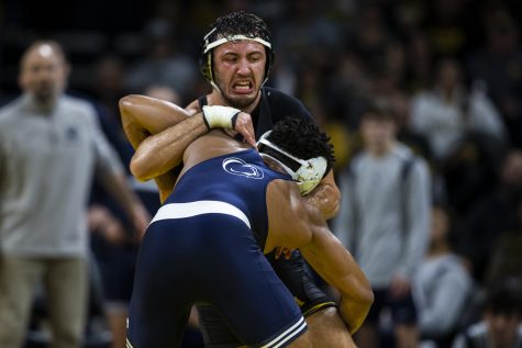 Iowa’s No. 2 174-pound and Pennsylvania native Michael Kemerer grapples with Penn State’s No. 1 Carter Starocci during a wrestling meet between No. 2 Iowa and No. 1 Penn State in Carver-Hawkeye Arena on Friday, Jan. 28, 2022. The Nittany Lions defeated the Hawkeyes, 19-13. Starocci defeated Kemerer in sudden victory, 2-1. During the 2021 Big Ten Tournament, Kemerer defeated Starocci, 7-2, but Starocci came back to defeat Kemerer, 3-1, by sudden victory in the 2021 NCAA finals. 