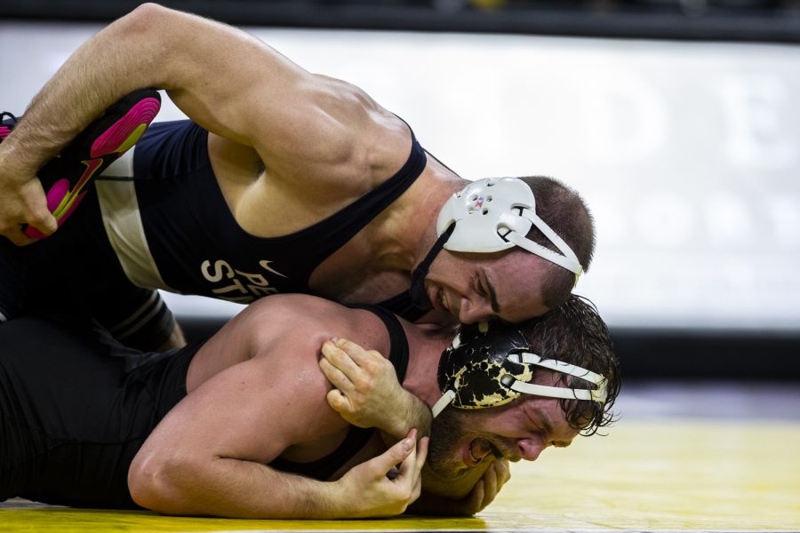 Penn State’s No. 2 197-pound Max Dean pressures Iowa’s No. 4  Jacob Warner during a wrestling meet between No. 2 Iowa and No. 1 Penn State in Carver-Hawkeye Arena on Friday, Jan. 28, 2022. Dean defeated Warner, 8-3. The Nittany Lions defeated the Hawkeyes, 19-13.