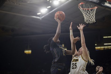 Northwestern foward Courtney Shaw goes up for a layup against Iowa center Monika Czinano during a women’s basketball game between No. 22 Iowa and Northwestern at Carver-Hawkeye Arena on Thursday, Jan. 6, 2022. The Wildcats defeated the Hawkeyes, 77-69. Shaw was 1-2 on free throws.