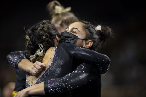 Iowa’s Marissa Rojas hugs teammate Clair Kaji after competing on beam during a gymnastics meet between No. 18 Iowa and Eastern Michigan at Carver-Hawkeye Arena on Saturday, Jan. 8, 2022. The Hawkeyes defeated the Eagles 195.950-194.100. 