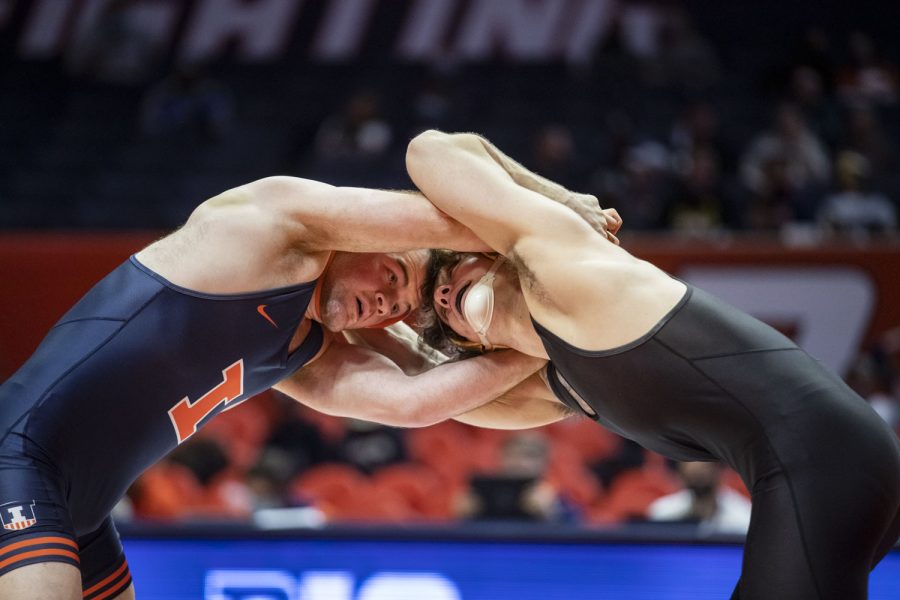 Iowa’s 184-pound No. 18 Abe Assad wrestles Illinois’ No. 19 Zac Braunagel during a wrestling dual between No. 2 Iowa and No. 21 Illinois at State Farm Center in Champaign, IL on Sunday, Jan. 16, 2022. Assad defeated Braunagel, 5-2, by decision. The Hawkeyes defeated the Fighting Illini 36-3. 