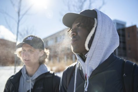 University of Iowa freshmen Jake Wise (left) and Zeke Ware (right) pose for a portrait near the Adler Journalism and Mass Communication Building on Tuesday, Jan. 25, 2022. Wise said, “It’s cold getting to class.” The expected high was 7 degrees and the expected low was negative 12 degrees. 
