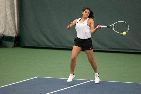 Iowa’s Vipasha Mehra hits the ball during a doubles match in a tennis meet between Iowa and Marquette on Sunday, Jan. 16, 2022. The Hawkeyes defeated the Golden Eagles, 6-1.