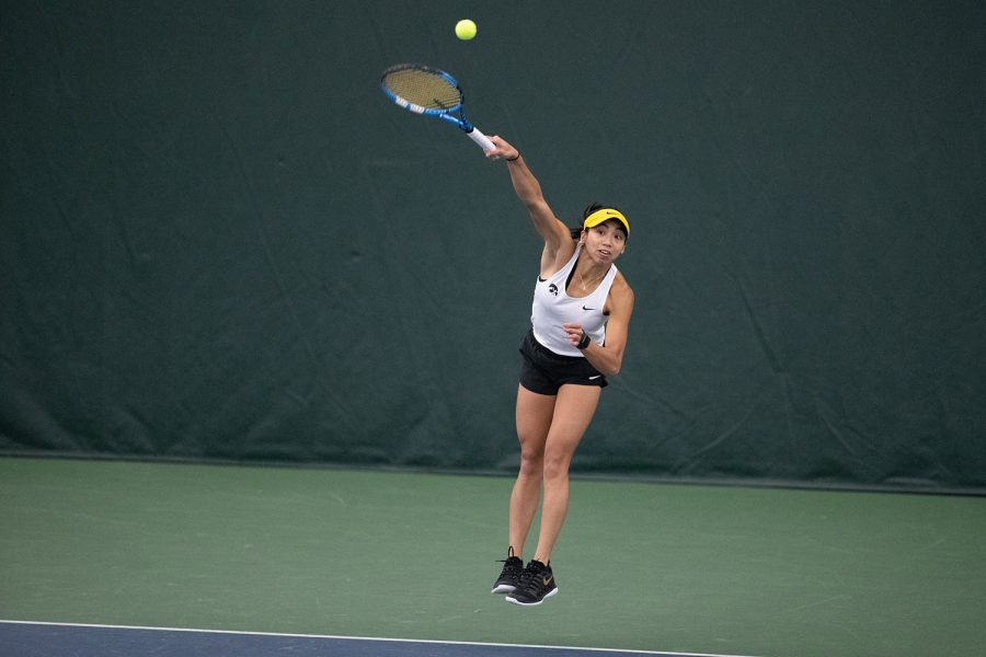Iowa’s Michelle Bacalla serves the ball into play during a singles match at the Iowa Womens Tennis meet in Iowa City on Sunday, Jan. 16, 2022. Bacalla won the match, 2-1. The Hawkeyes defeated the Golden Eagles, 6-1.