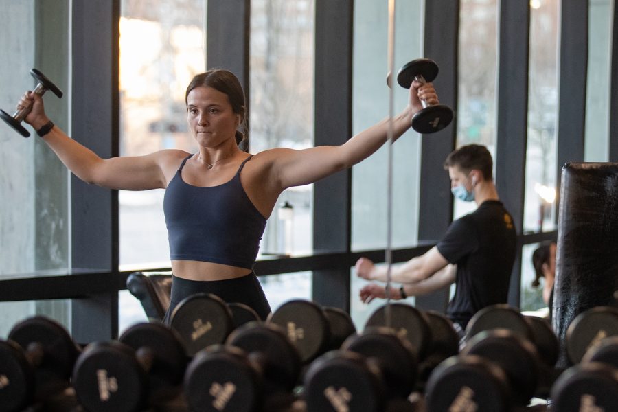 A student lifts weights at the Campus Recreational and Wellness Center in Iowa City on Wednesday, Jan. 26, 2022. 