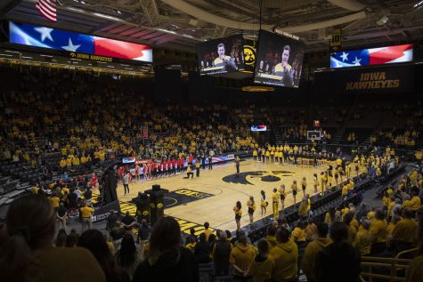 Fans stand during the National Anthem at a women’s basketball game between No. 21 Iowa and No. 23 Ohio State at Carver-Hawkeye Arena in Iowa City on Monday, Jan. 31, 2022. 6,185 people attended. The Buckeyes defeated the Hawkeyes, 92-88.