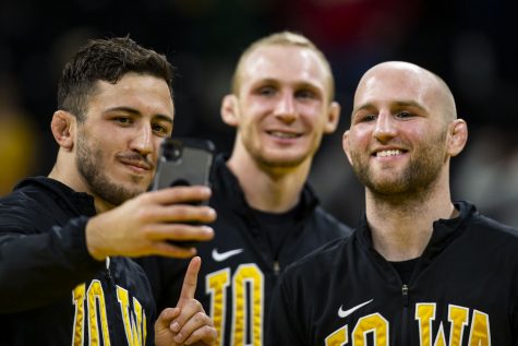 Iowa’s Michael Kemerer, Kaleb Young, and Alex Marinelli take a selfie after a wrestling meet between No. 2 Iowa and No. 9 Wisconsin in Carver-Hawkeye Arena in Iowa City, Iowa, on Saturday, Feb. 5, 2022. The Hawkeyes defeated the Badgers, 29-6.