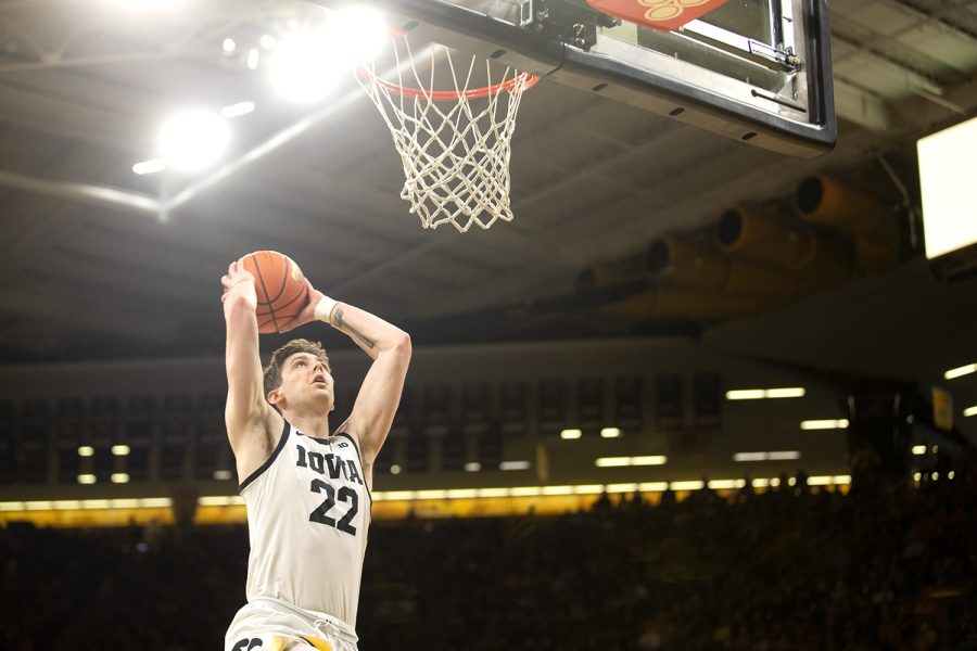 Iowa forward Patrick McCaffery attempts a dunk during a basketball game between Iowa and Minnesota at Carver-Hawkeye Arena on Sunday, Feb. 6, 2022. The Hawkeyes defeated the Golden Gophers, 71-59. McCaffery had 18 total points and 7 rebounds.