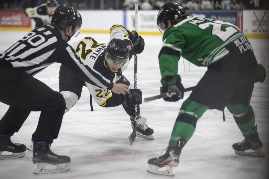 Heartlanders forward Zach White faces off against Utah’s forward Mason Mannek during the Iowa Heartlanders and Utah Grizzlies hockey game at Xtream Arena in Coralville, Iowa, on Friday, Feb. 11, 2022. The Grizzlies defeated the Heartlanders, 5-2.
