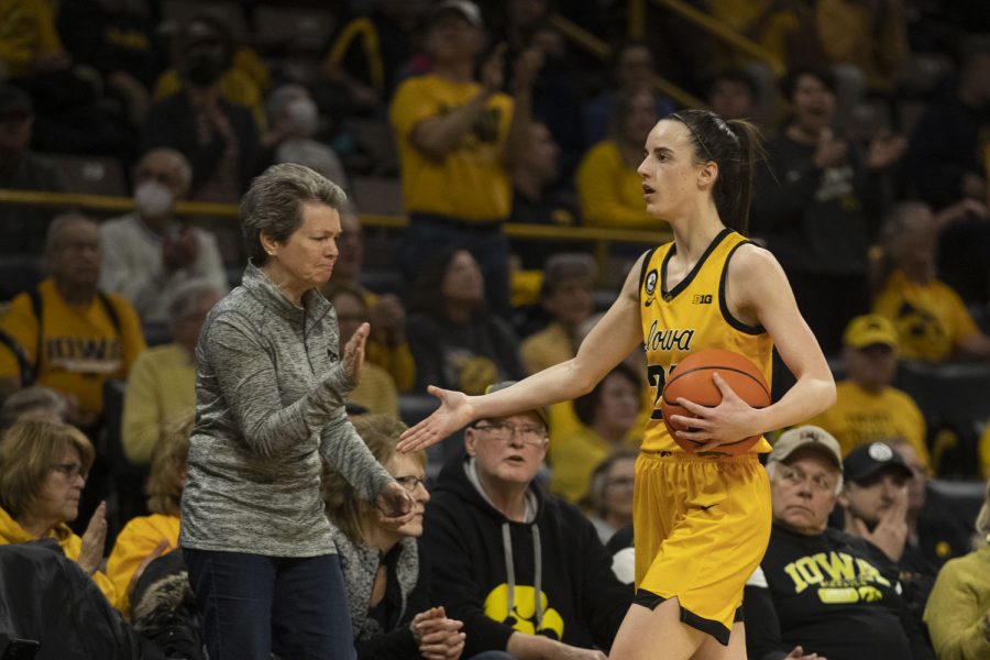 Iowa guard Caitlin Clark high-fives a spectator during a women’s basketball game between No. 21 Iowa and No. 10 Indiana at Carver-Hawkeye Arena in Iowa City on Monday, Feb. 21, 2022. The Hawkeyes defeated the Hoosiers, 88-82. Clark was second in team scoring with 29 points. 