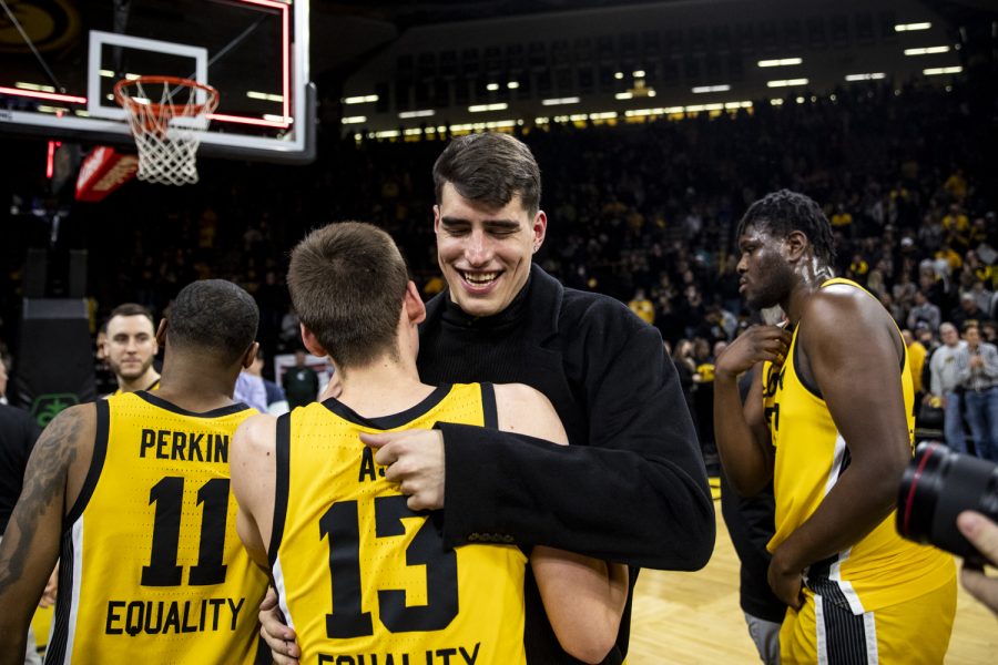 Former Iowa center Luka Garza hugs Iowa guard Austin Ash after a win during a men’s basketball game at Carver-Hawkeye Arena between No. 25 Iowa and Michigan State on Tuesday, Feb. 22, 2022. Ash scored four points and saw about four minutes of playtime in the blowout win. The Hawkeyes defeated the Spartans, 86-60. With the victory, Iowa notched win No. 500 inside Carver-Hawkeye Arena.