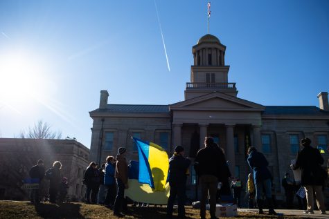 Demonstrators gather during a rally for peace in Ukraine on the Pentacrest at the University of Iowa in Iowa City. Around 60 people attended the demonstration. 