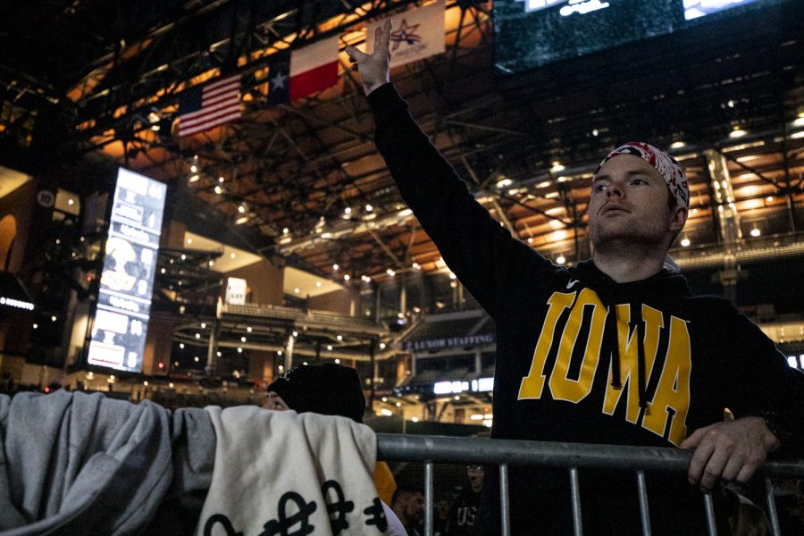 An Iowa fan cheers after a takedown during the Bout at the Ballpark wrestling dual between No. 2 Iowa and No. 12 Oklahoma at Globe Life Field on Saturday, Feb. 12, 2022. The Hawkeyes defeated the Cowboys 23-9.