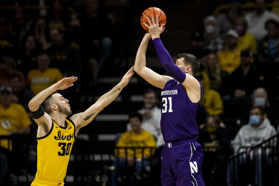 Iowa guard Connor McCaffery contests a shot from Northwestern forward Robbie Beran during a men’s basketball game between No. 24 Iowa and Northwestern in Carver-Hawkeye Arena on Monday, Feb. 28, 2022. Beran did not make a shot. The Hawkeyes defeated the Wildcats, 82-61.