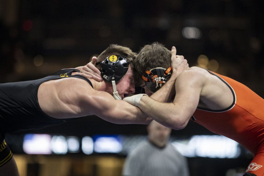 Iowa’s 149-pound No. 10 Max Murin wrestles Oklahoma State’s No. 13 Kaden Gfeller during the Bout at the Ballpark wrestling dual between No. 2 Iowa and No. 12 Oklahoma State at Globe Life Field in Arlington, TX on Saturday, Feb. 12, 2022. Murin defeated Gfeller, 5-2, by decision. The Hawkeyes defeated the Cowboys 23-9. (Ayrton Breckenridge/The Daily Iowan)