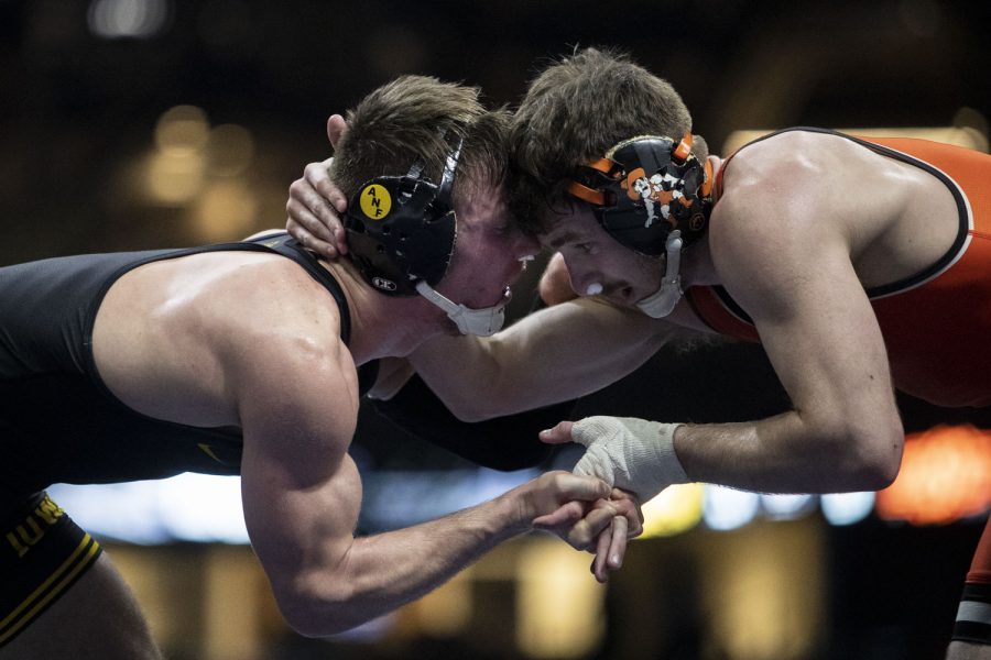 Iowa’s 149-pound No. 10 Max Murin wrestles Oklahoma State’s No. 13 Kaden Gfeller during the Bout at the Ballpark wrestling dual between No. 2 Iowa and No. 12 Oklahoma State at Globe Life Field in Arlington, TX on Saturday, Feb. 12, 2022. Murin defeated Gfeller, 5-2, by decision. The Hawkeyes defeated the Cowboys 23-9. (Ayrton Breckenridge/The Daily Iowan)