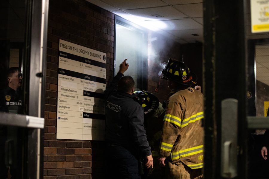Iowa City cops and firefighters investigate at the English-Philosophy Building at the University of Iowa on Sunday, Feb. 20, 2022. Hot water spewed out of a pipe after a pipe leak.