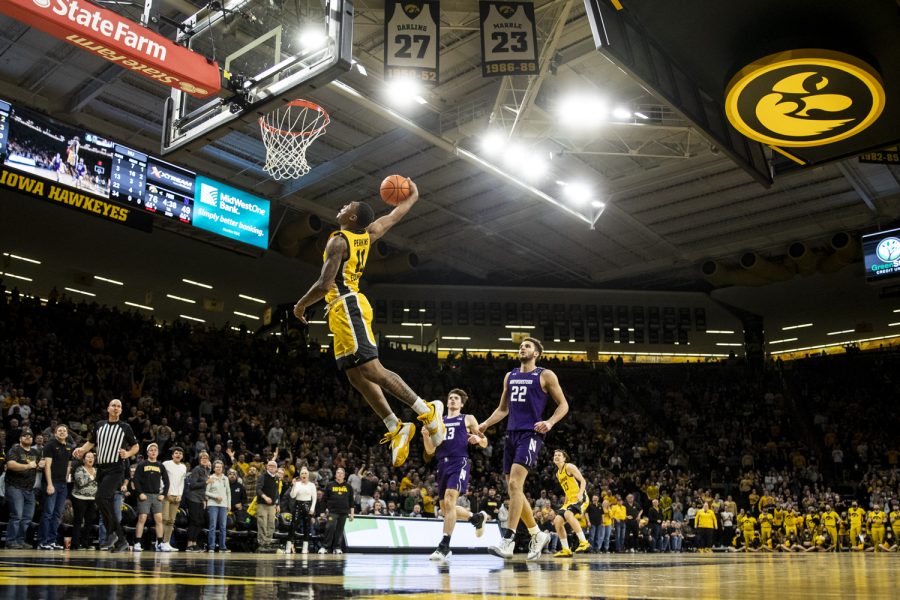 Iowa guard Tony Perkins attempts to windmill dunk during a men’s basketball game between No. 24 Iowa and Northwestern in Carver-Hawkeye Arena on Monday, Feb. 28, 2022. Perkins scored six points. The Hawkeyes defeated the Wildcats, 82-61.