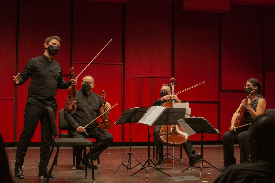 Violinists Ari Isaacman-Beck introduces violinist Carlos Rubio, cellist Jesús Morales, and violist Adriana Linares in a strings group called the Dalí Quartet at the Voxman Music Building in Iowa City on Thursday, Feb. 3, 2022.