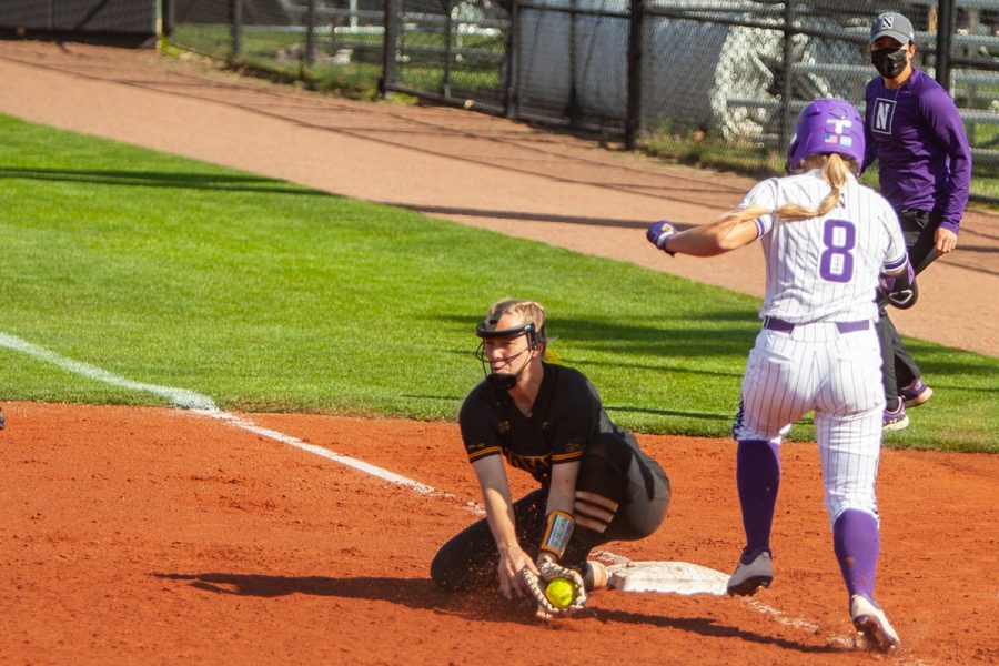 Iowa utility player Denali Loecker catches the ball for a force out during a softball game between Iowa and Northwestern at Bob Pearl Softball Field on Saturday, April 17, 2021. The Wildcats defeated the Hawkeyes 9-7. 