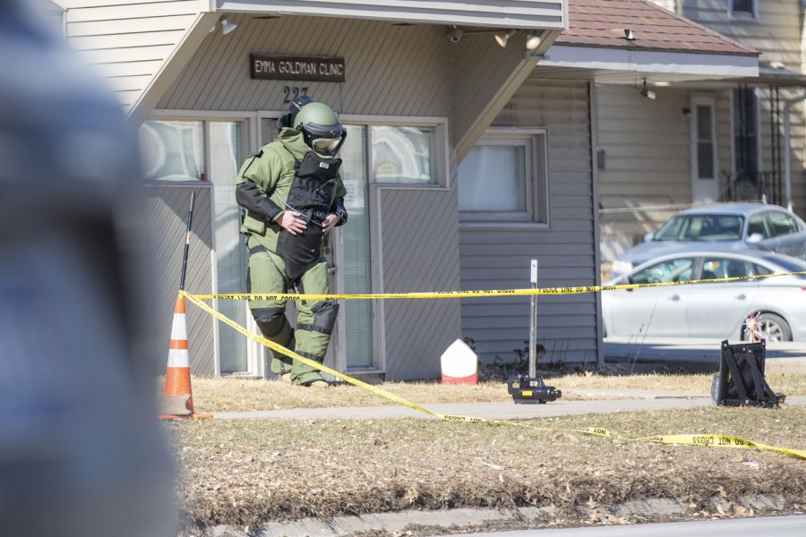 A member of the Metro Area Bomb Squad steps away from a package in front of Emma Goldman Clinic in Iowa City on Friday, Feb. 18, 2022. The University of Iowa issued a Hawk Alert describing the package as “suspicious” around 11:20 a.m.