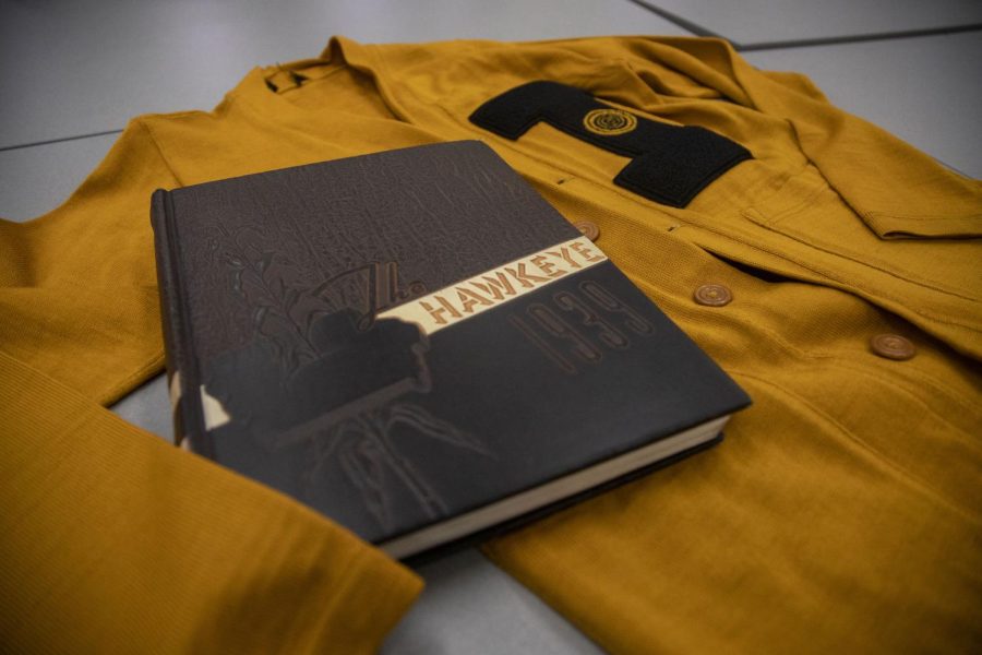 A 1939 University of Iowa yearbook and ‘60s UI sweater sit in the UI Libraries Special Collections on Friday, Oct. 29, 2021. Several historical items were gathered for a display that celebrates the university’s 175th anniversary. 