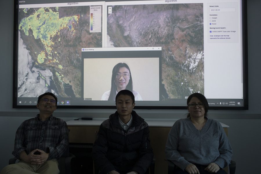 Professor Jun Wang, Lorena Castro García, Xi Chen, and Zhendong Lu pose for a group portrait before their work on the projector in Iowa City on Feb. 7, 2022. The projector depicts their California wildfire smoke elevations.