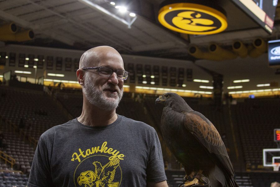 UI Wild director David Conrads poses with a hawk at Carver-Hawkeye Arena in Iowa City on Feb. 9, 2022.