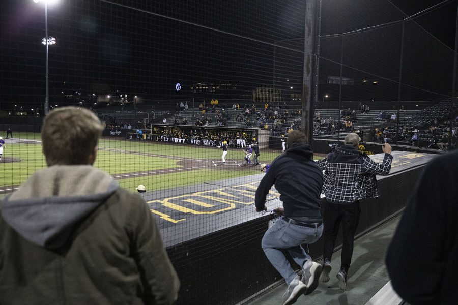 Fans celebrate after Loras stunned Iowa in their home opener, 3-1, during a baseball game between Iowa and Loras College at Duane Banks Field in Iowa City on Tuesday, March 1, 2022. 