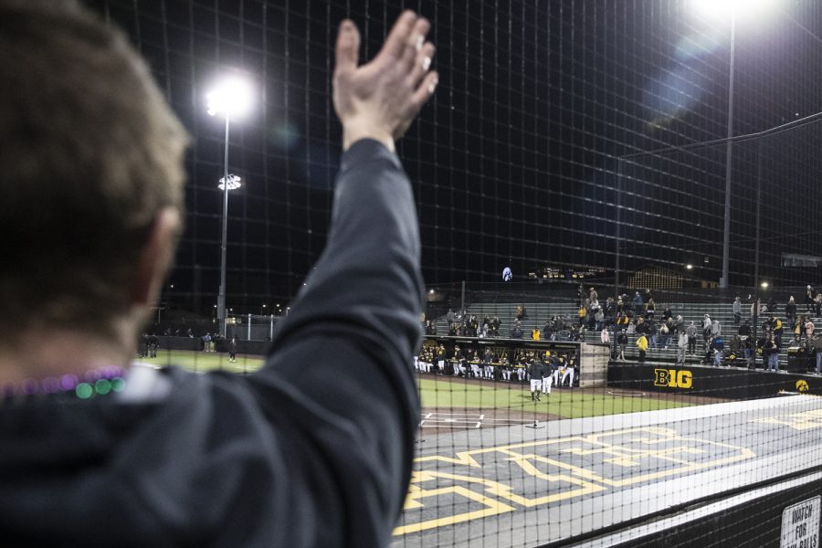 A Loras fan waves goodbye to Iowa’s club after a baseball game between Iowa and Loras College at Duane Banks Field in Iowa City on Tuesday, March 1, 2022. Loras College, a division three team, made the trip to Iowa City from Dubuque, Iowa. The Duhawks stunned the Hawkeyes, 3-1.