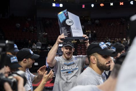 Michigan’s No. 5 Patrick Brucki holds up the Big Ten Championship trophy after session five of the Big Ten Wrestling Championships at Pinnacle Bank Arena in Lincoln, Neb., on Sunday, March 6, 2022. Michigan won the Big Ten Championship with 143.