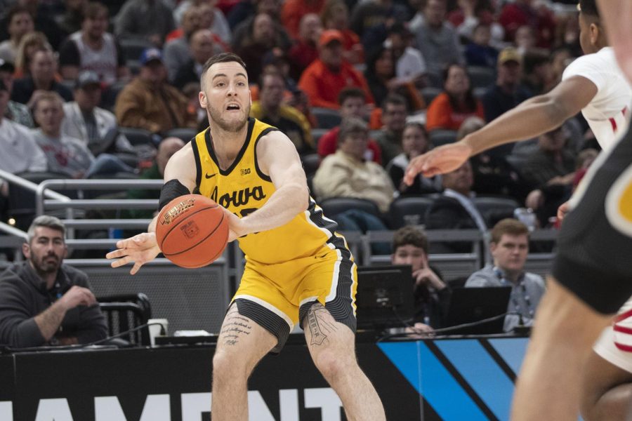 Iowa forward Connor McCaffery passes the ball during an 84-74 win over Rutgers in the quarterfinals of the Big Ten Tournament at Gainbridge Fieldhouse in Indianapolis on March 11, 2022.