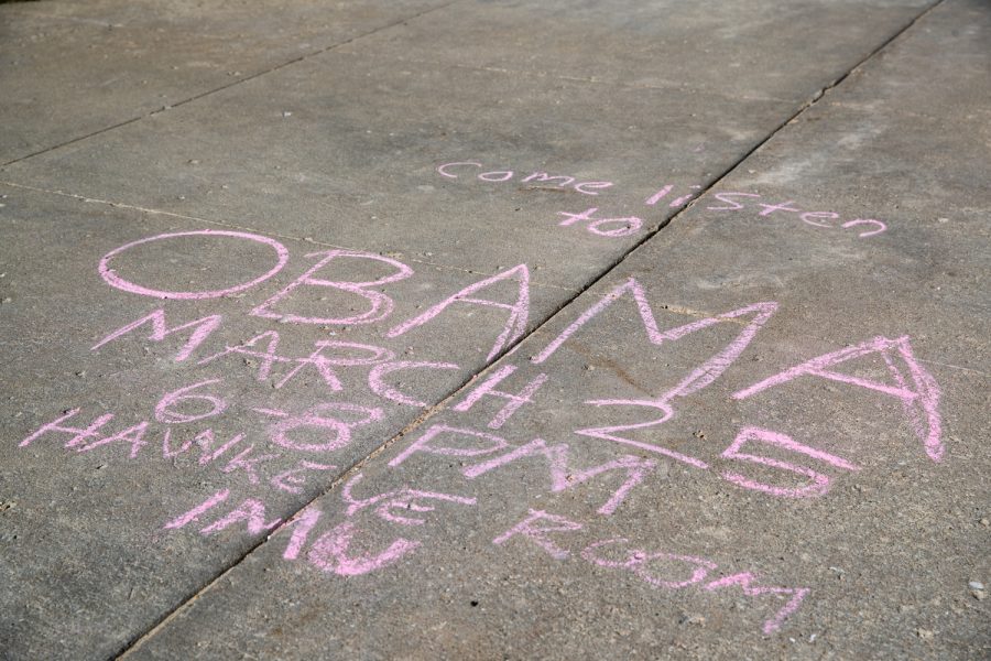 Sidewalk chalk, telling passerby that former President Barack Obama will speak at the Hawkeye Room in the Iowa Memorial Union, is seen on the Pentacrest at the University of Iowa on Monday, March 21, 2022. 