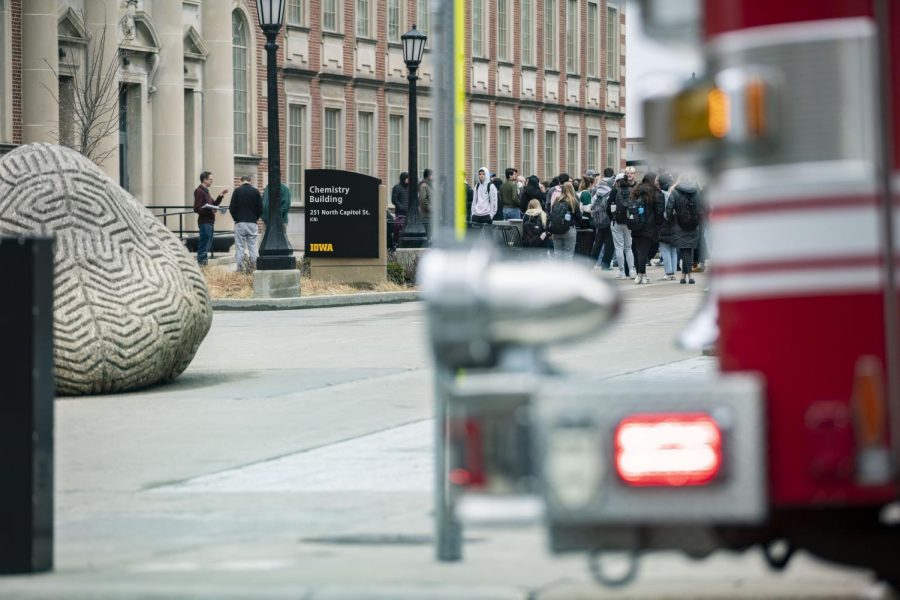 Students and faculty stand outside of the University of Iowa Chemistry Building while first responders investigate a “strong smell of gas” coming from the building according to a University Hawk Alert on Thursday, March 24, 2022. According to a later Hawk Alert, the situation was resolved. 