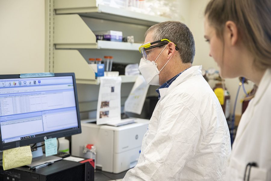 IIHR-Hyrdroscience and Engineering Assistant Research Scientist Drew Latta (left) and Graduate Research Assistant in the department of civil and environmental engineering Danielle Land (right) look over data in the Seamans Center on Tuesday, March 29, 2022. They are part of a group that is developing an online tool that identifies which homes might be at risk of water contamination from lead. 