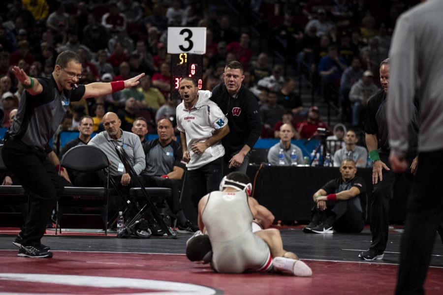 Wisconsin’s head wrestling coach Chris Bono celebrates a takedown from Wisconsin’s No. 2 Austin Gomez on Ohio State’s No. 1 Sammy Sasso  during session five of the Big Ten Wrestling Championships at Pinnacle Bank Arena in Lincoln, Neb., on Sunday, March 6, 2022. Gomez defeated Sasso to earn first place in a 149-pound match .