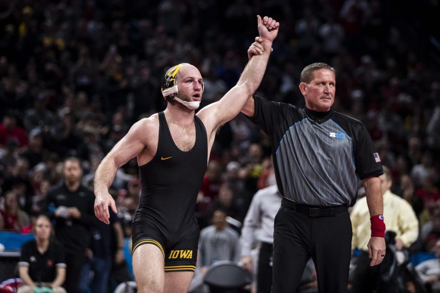 Iowa’s No. 2 Alex Marinelli raises his hand after earning first place during session five of the Big Ten Wrestling Championships at Pinnacle Bank Arena in Lincoln, Neb., on Sunday, March 6, 2022. Marinelli defeated Michigan’s No. 4 Cameron Amine  in a 165-pound match, 2-1.
