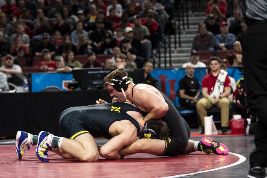 Michigan’s No. 5 Patrick Brucki holds down Iowa’s No. 4 Jacob Warner during session five of the Big Ten Wrestling Championships at Pinnacle Bank Arena in Lincoln, Neb., on Sunday, March 6, 2022. Brucki defeated Warner in a 197-pound match to earn third place.