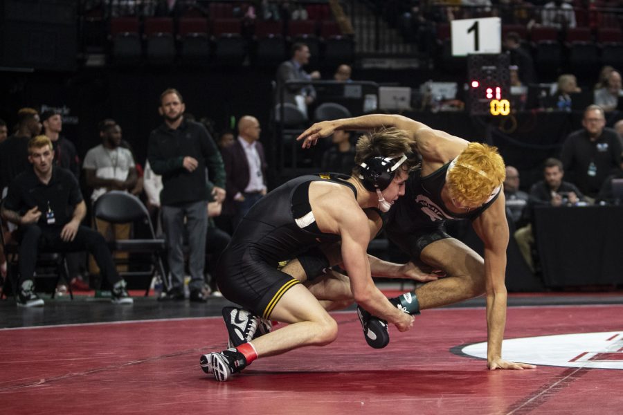 Iowa’s No. 6 Drake Ayala lunges for Michigan State’s No. 11 Tristan Lujan’s legs during session one of the Big Ten Wrestling Championships at Pinnacle Bank Arena in Lincoln, Neb., on Saturday, March 5, 2022. Ayala defeated Lujan in a 125-pound match, 4-0.